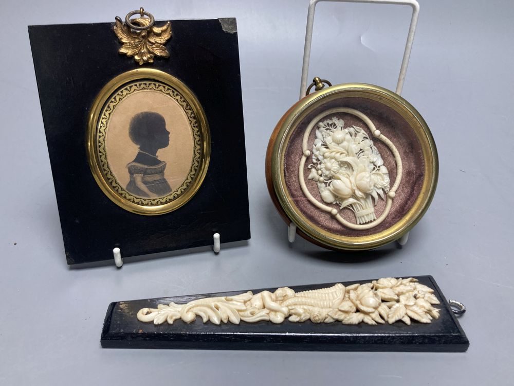 A Cantonese carved ivory basket of flowers, framed, Dieppe carved ivory applique panel and a Victorian portrait silhouette, 11 x 13cm o